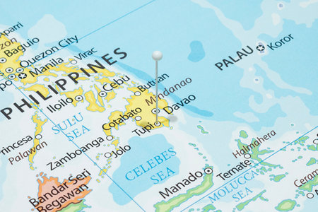 Close up to a Tupi city with a white pin needle into Philippines country political mapの写真素材