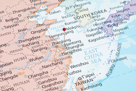 Close up to a Shanghai city with a red pin needle into China country political mapの写真素材