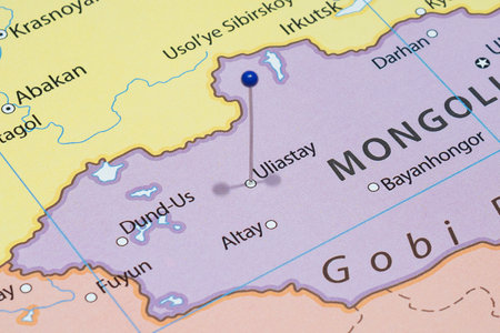 Close up to a Uliastai city with a blue pin needle into Mongolia country political mapの写真素材