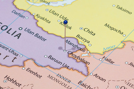Close up to a Choibalsan city with a blue pin needle into Mongolia country political mapの写真素材