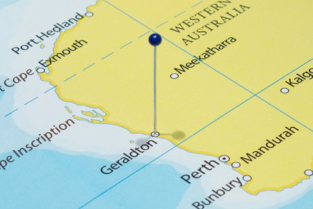 Close up to a Geraldton city with a blue pin needle into Australia country political mapの写真素材