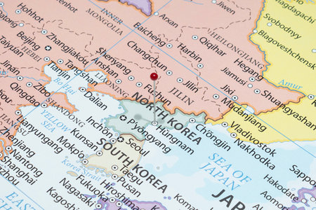 Close up to a Hungnam city with a red pin needle into North Korea country political mapの写真素材