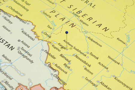 Close up to a Kargat city with a blue pin needle into Russia country political mapの写真素材