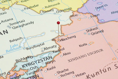 Close up to a Huocheng city with a red pin needle into China country political mapの写真素材