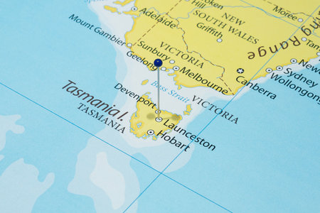 Close up to a Launceston city with a blue pin needle into Australia country political mapの写真素材