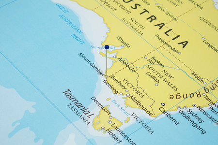 Close up to a Mount Gambier city with a blue pin needle into Australia country political mapの写真素材