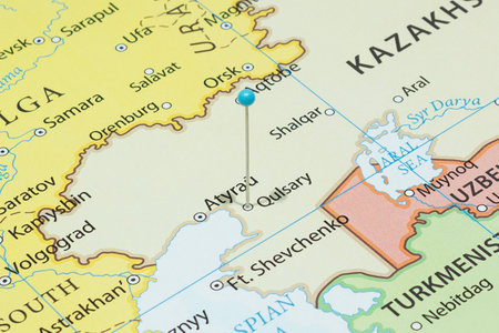 Close up to a Kulsary city with a light blue pin needle into Kazakhstan country political mapの写真素材