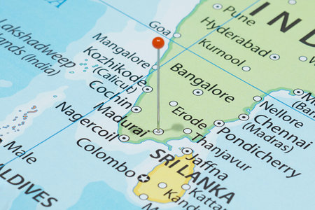 Close up to a Madura city with an orange pin needle into India country political mapの写真素材