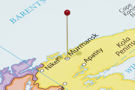 Close up to a Murmansk city with a red pin needle into Russia country political mapの写真素材