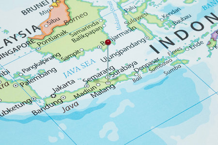 Close up to a Malang city with a red pin needle into Indonesia country political mapの写真素材
