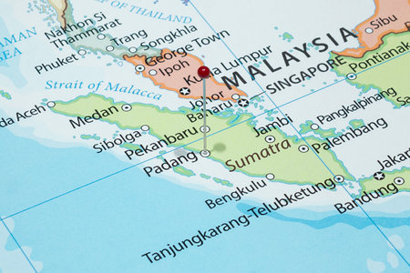 Close up to Padang city with a red pin needle into Indonesia country political mapの写真素材