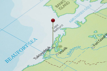 Close up to a Tuktoyaktuk with a red pin needle into Canada country political mapの写真素材