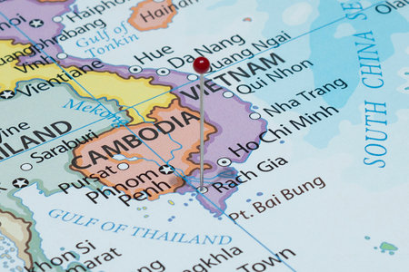 Close up to a Rach Gia city with a red pin needle into Vietnam country political mapの写真素材