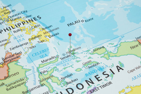 Close up to a Ternate city with a red pin needle into Indonesia country political mapの写真素材