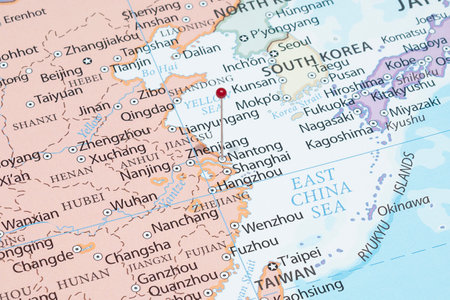 Close up to a Nantong city with a red pin needle into China country political mapの写真素材