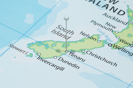 Close up to a Timaru city with a white pin needle into New Zealand country political mapの写真素材