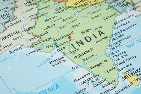 Close up to a Pune city with an orange pin needle into India country political mapの写真素材