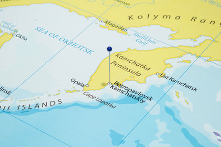 Close up to a Petropavlovsk Kamchatskiy city with a blue pin needle into Russia country political mapの写真素材