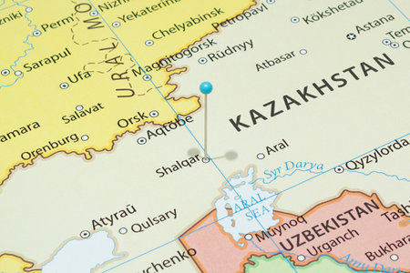 Close up to a Shalkar city with a light blue pin needle into Kazakhstan country political mapの写真素材