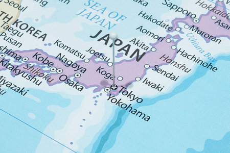 Close up to a Tokyo city with a white pin needle into Japan country political mapの写真素材