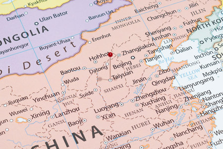 Close up to a Taiyuan city with a red pin needle into China country political mapの写真素材