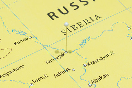Close up to a Yeniseysk city with a white pin needle into Russia country political mapの写真素材
