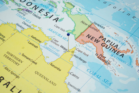 Close up to a city with a blue pin needle into a country political mapの写真素材