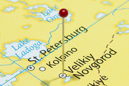 Close up to a Veliky Novgorod city with a red pin needle into Russia country political mapの写真素材
