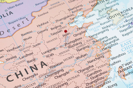 Close up to a Xuchang city with a red pin needle into China country political mapの写真素材