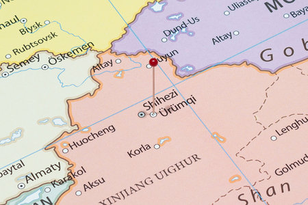 Close up to a Urumqi city with a red pin needle into China country political mapの写真素材