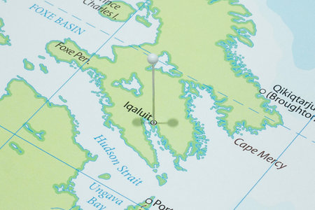 Close up to a Iqaluit city with a white pin needle into Canada country political mapの写真素材