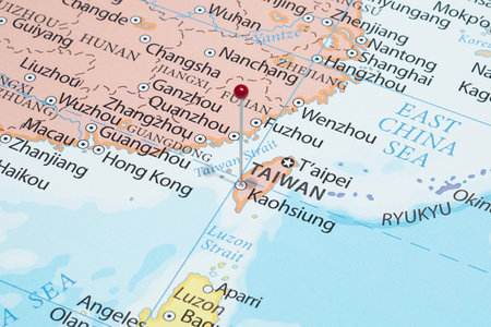 Close up to a Kaohsiung city with a red pin needle into Taiwan country political mapの写真素材