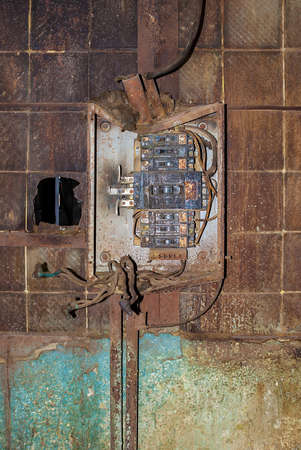 Broken junction box in the workshop of abandoned factory