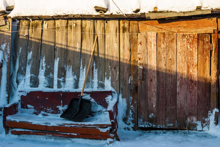 The facade of the old rustic barn in winter sunny dayの写真素材