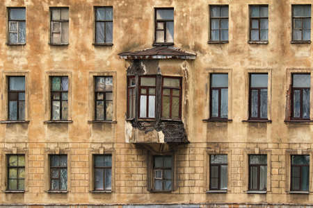 Windows in a row and bay window on facade of apartment buildingの写真素材