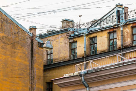 Composition of pieces of three different facades of apartment buildings with a lot of wiresの写真素材