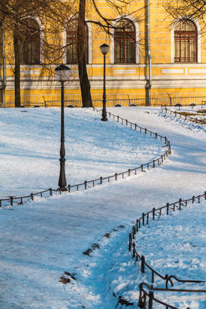 Footpah in Yusupov garden and facade of Petersburg State Transport University's building in winter sceneの写真素材