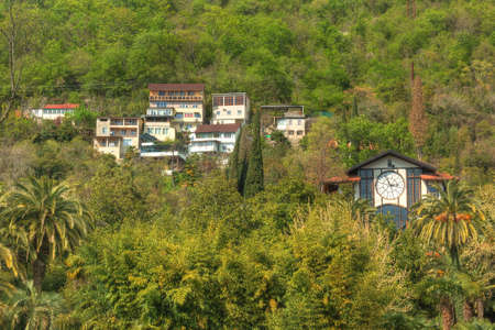 Gagra, Abkhazia, Georgia - April 3, 2016: View of the apartment buildings and the restaurant "Gagripsh" on a mountainside among the trees, HDR processingのeditorial素材