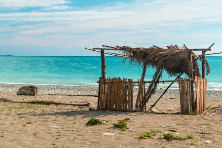 Bamboo fisherman hut on the seashore on sunny dayの写真素材