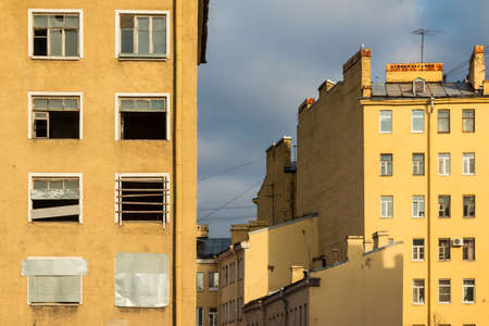 Composition of different facades of apartment buildings on the background of cloudy skyの写真素材