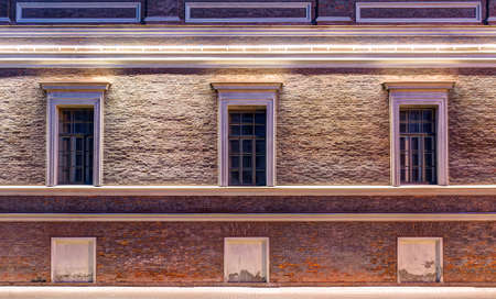 Several windows in a row on night illuminated facadeの写真素材