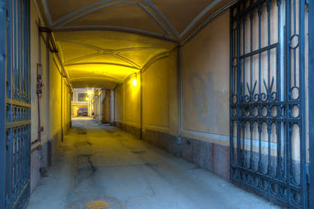 Illuminated arch in old urban office building in St. Petersburg, Russiaの写真素材