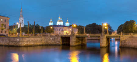 Night view on illuminated Griboedov Canal, Pikalov Bridge and St. Nicholas Naval Cathedral, St. Petersburg, Russiaの写真素材