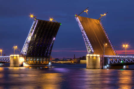 Night view on illumunated open Palace Bridge and Neva River, St. Petersburg, Russiaの写真素材