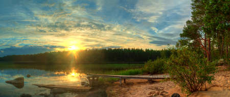 Beautiful sunset on the shore of lakeの写真素材
