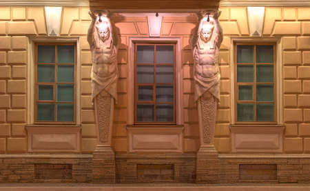 St. Petersburg, Russia - August 4, 2016: Three windows in a row and sculptures on night illuminated facade of Russian Maritime Register of Shipping front viewのeditorial素材