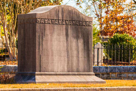 The concrete tombstone closeup on the Oakland Cemetery in sunny autumn day, Atlanta, USAの写真素材