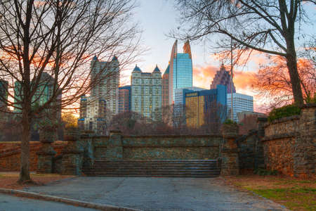 View of stone stairs in the Piedmont Park and Midtown Atlanta behind it in autumn evening, USAの写真素材