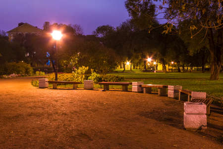 Night view of park and footpath with benches in Yusupov Garden, Saint Petersburg, Russiaの写真素材