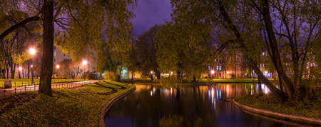 Dusk panoramic autumn view of park and pond in Yusupov Garden, Saint Petersburg, Russiaの写真素材